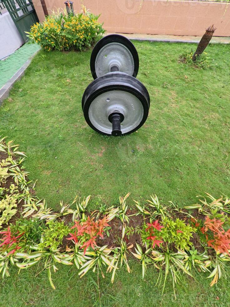 Heavy Train Wheels Resting on Green Grass photo
