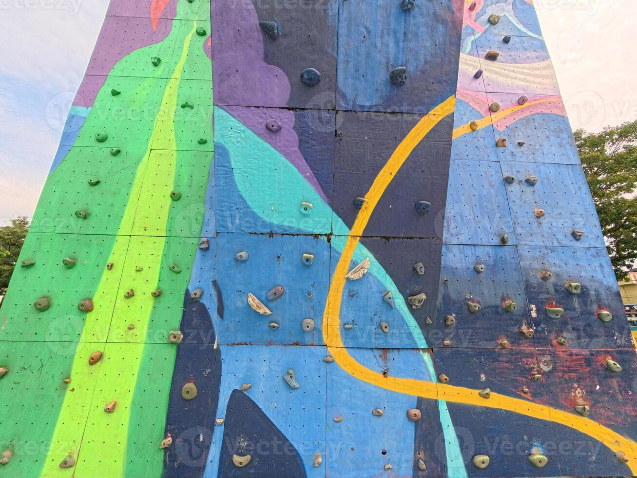 Colorful Rock Climbing Wall with Handholds photo