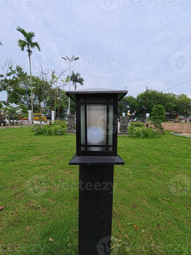 Modern Lamp Post in Green Park Setting photo