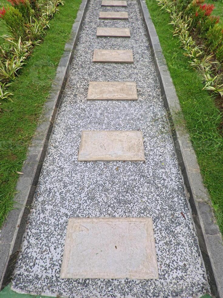 Stone Pathway Leading Through Tranquil Garden Scene photo