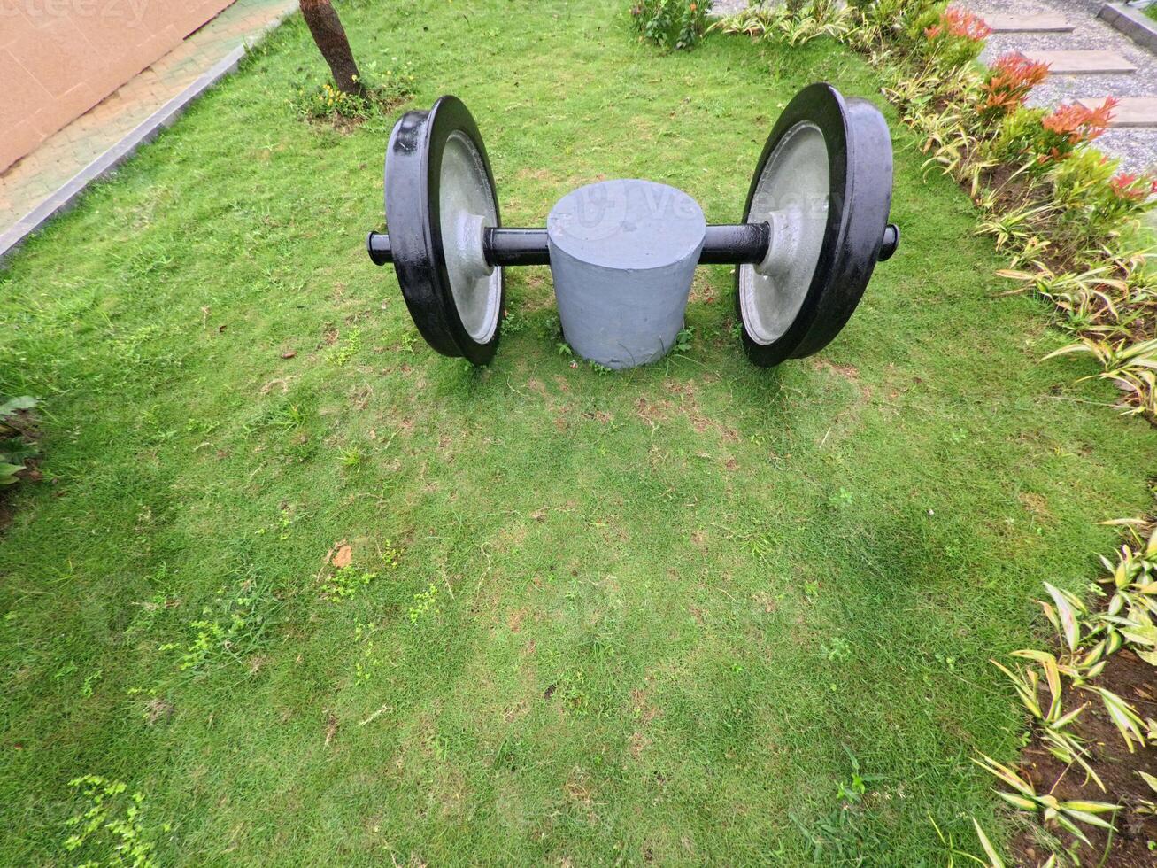 Iron Train Wheels Resting on Green Grass photo