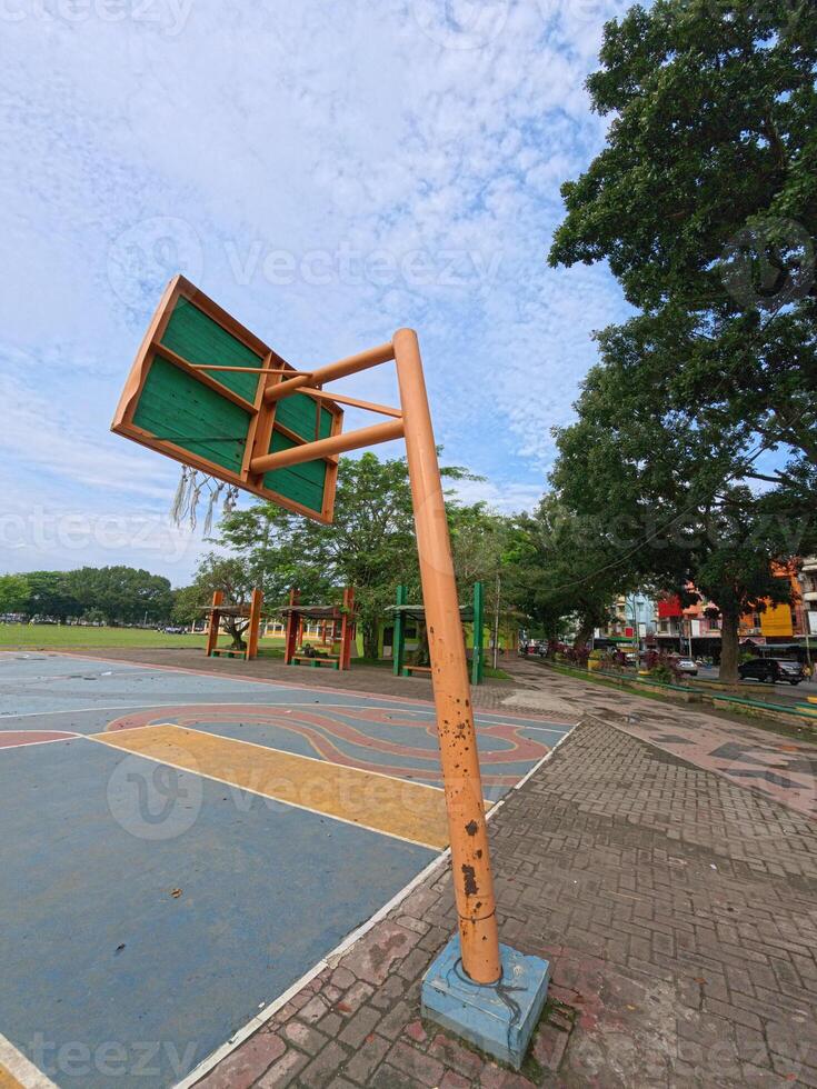 Rustic Basketball Hoop with Cloudy Sky Background photo