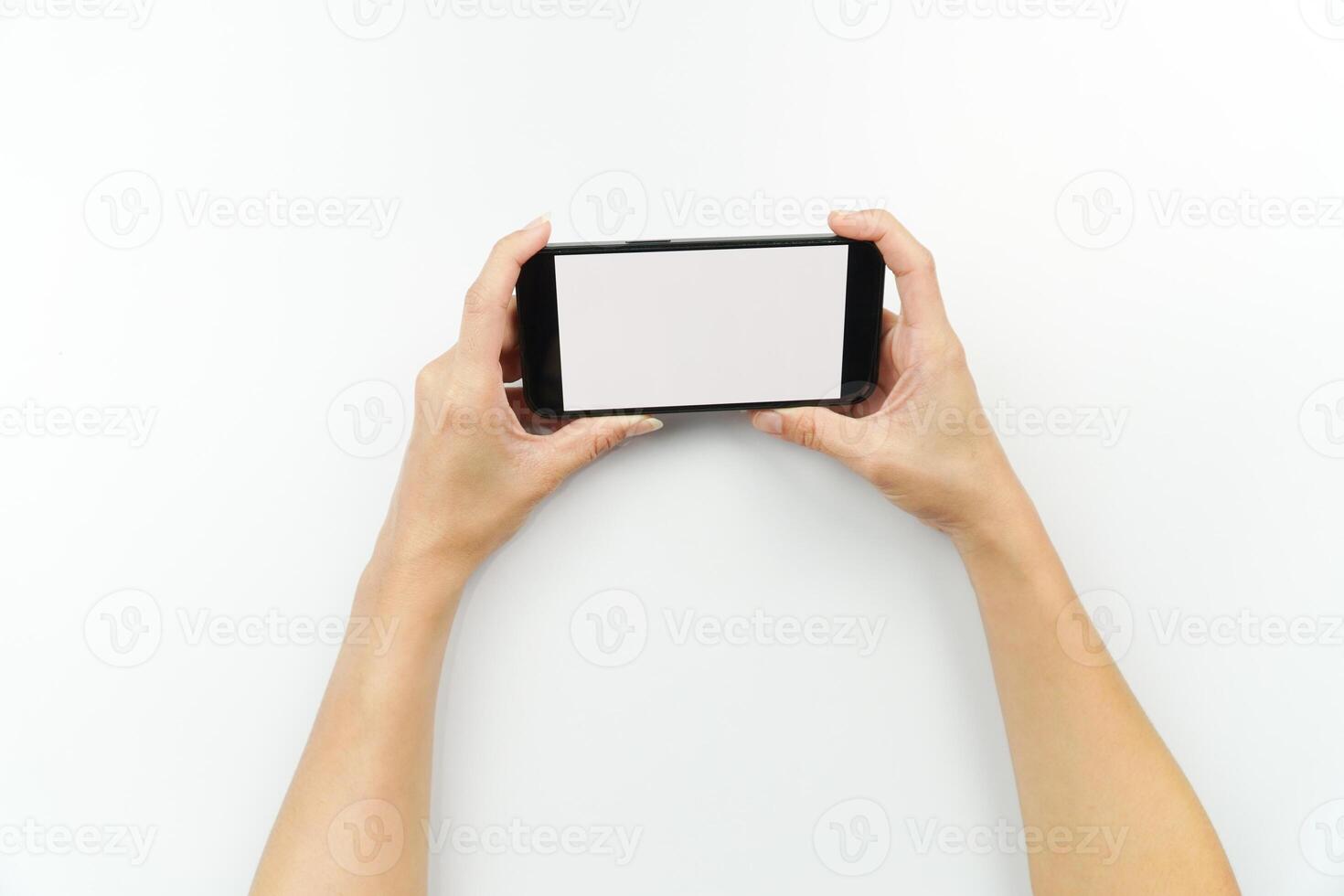 Hands holding up a smartphone with blank screen photo