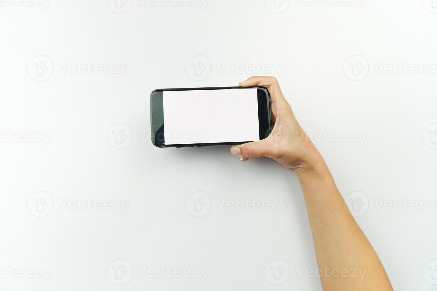 Hand holding a smart phone with blank screen photo