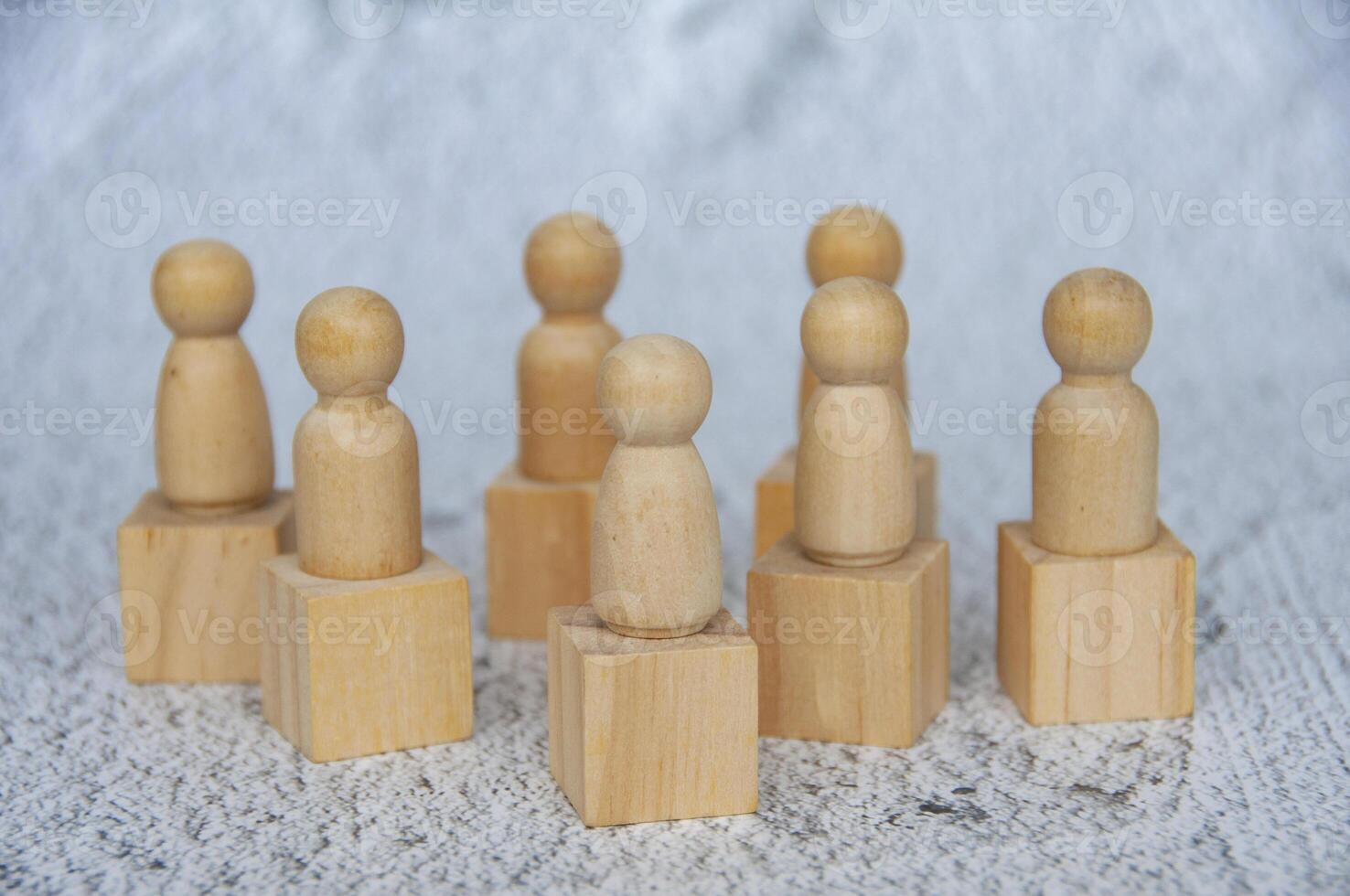 Wooden figure dolls on top of wooden cube representing that everyone is a winner photo