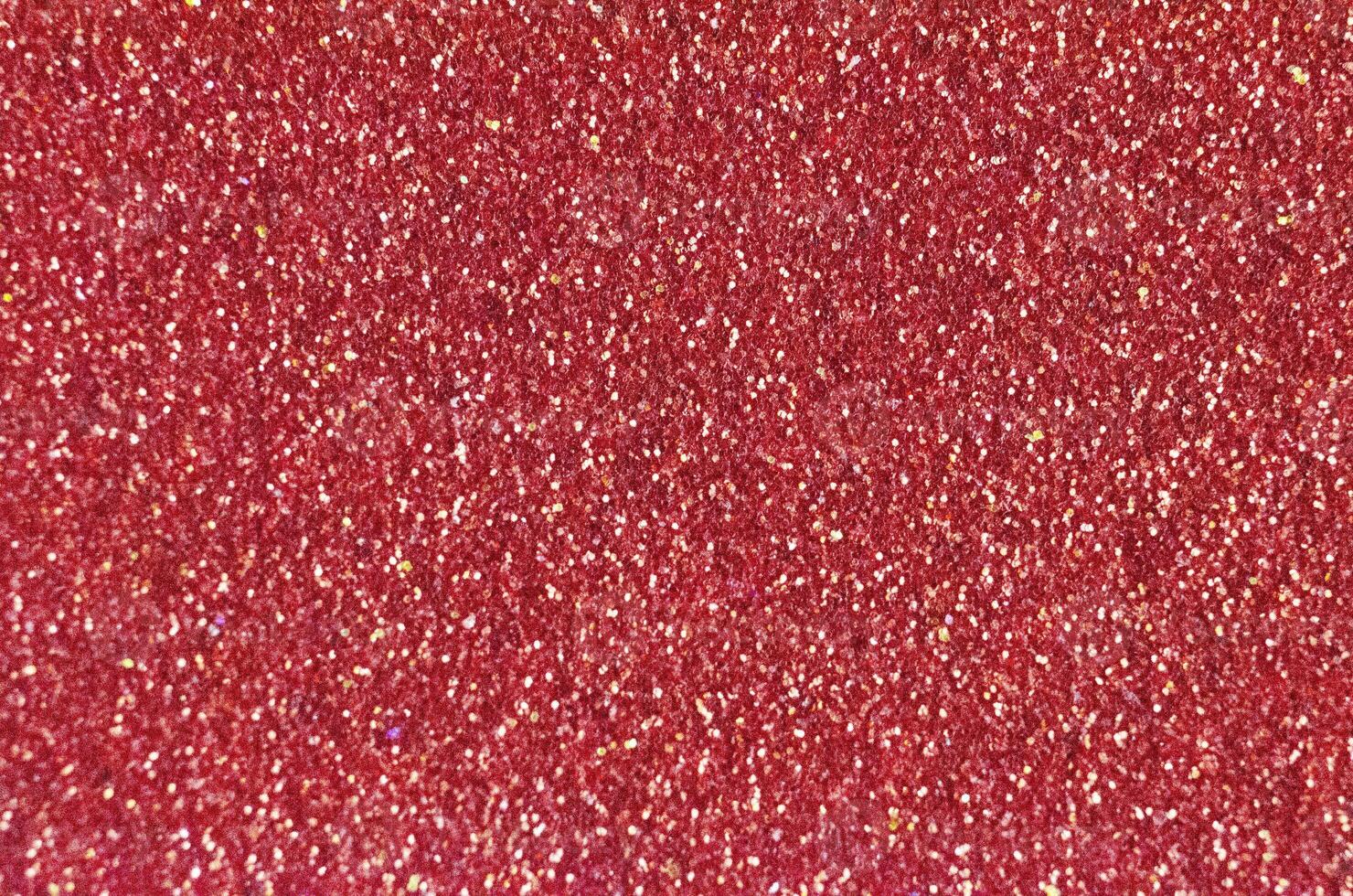 Close up of a dark red glitter or sparkle texture and can be used as a background or wallpaper for designs. photo