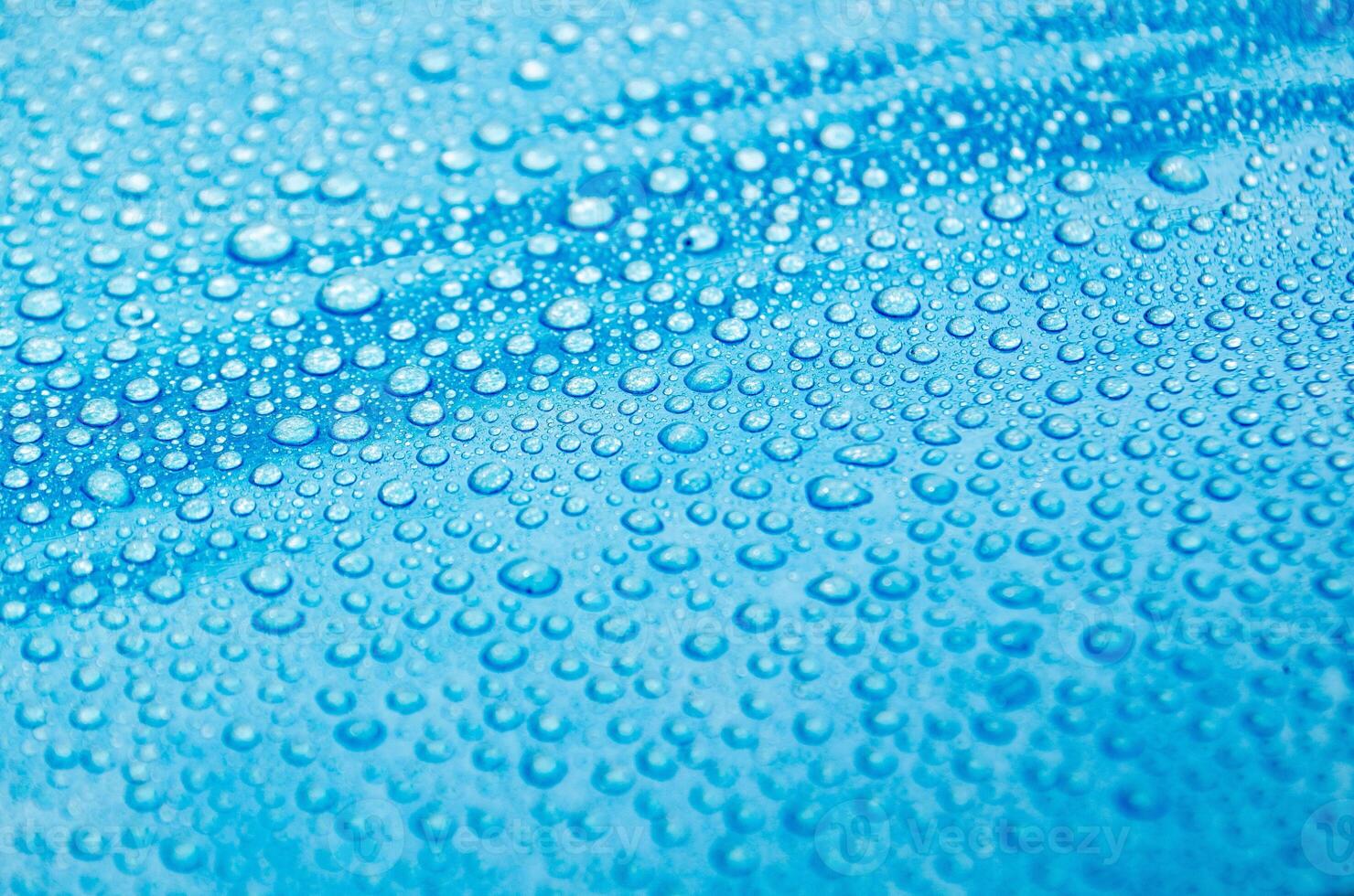 Side view of droplets with blue color background suitable for wallpaper photo