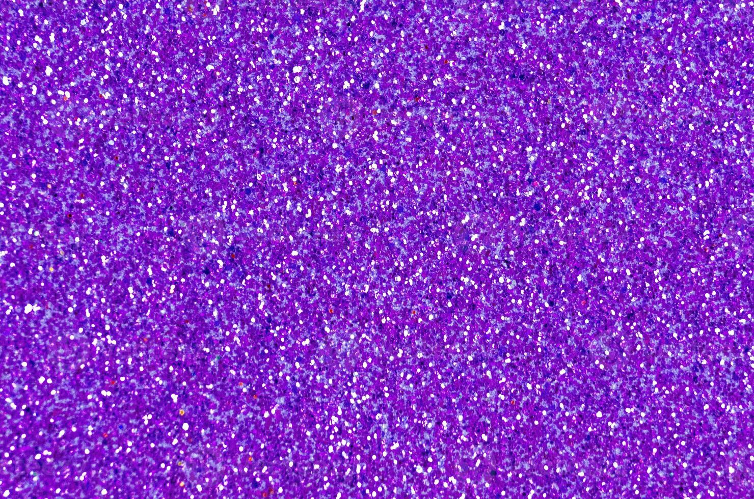 Close up of a purple glitter or sparkle texture and can be used as a background or wallpaper for designs photo