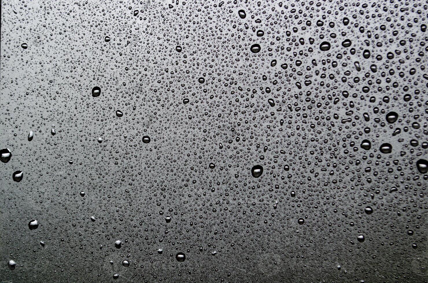 Water droplets with dark background suitable for wallpaper decoration photo