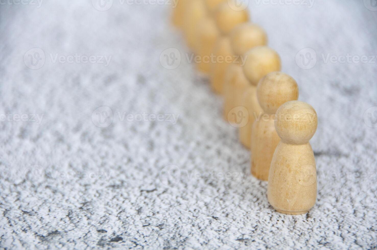 A wooden figure leading other wooden figures with customizable space for text. Leadership concept photo