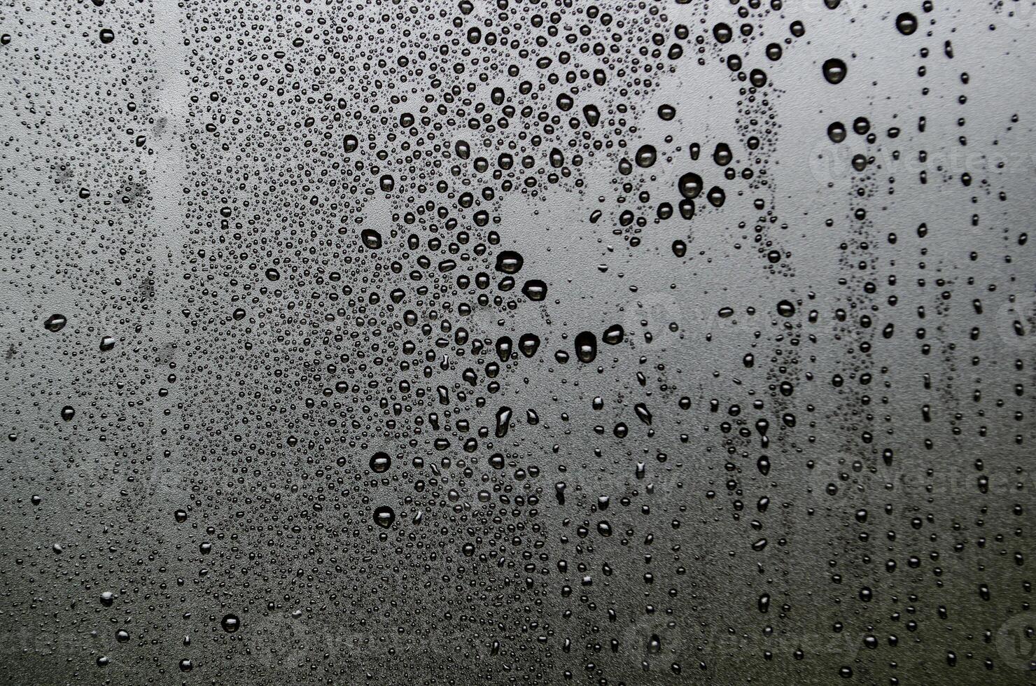 Water droplets view from above with dark background. photo