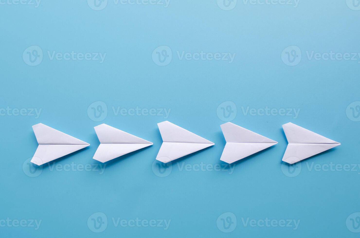 Top view of origami white paper airplanes with customizable space for text photo