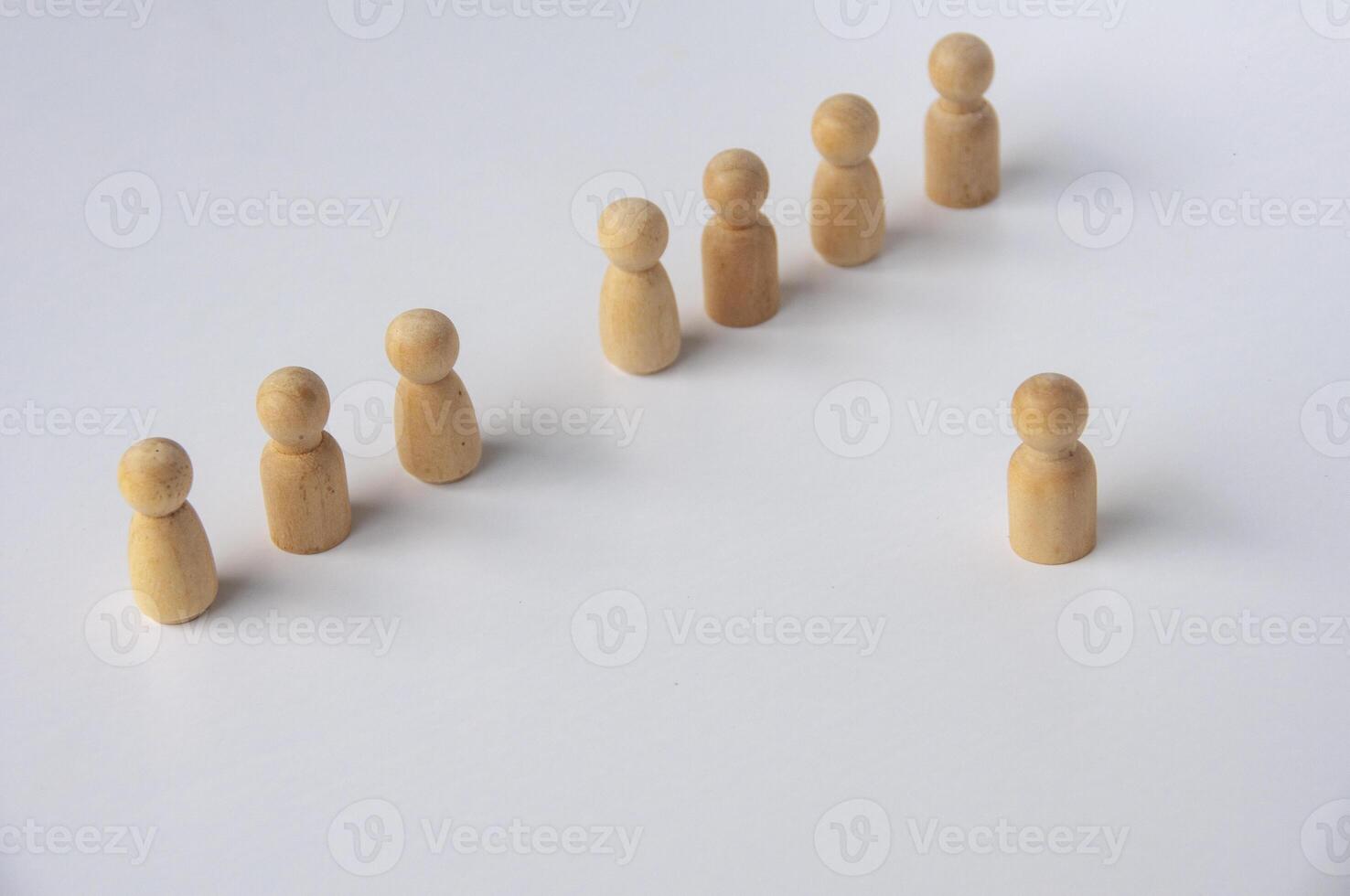 A wooden figure stepping out to lead other figures with customizable space for text. Leadership concept photo