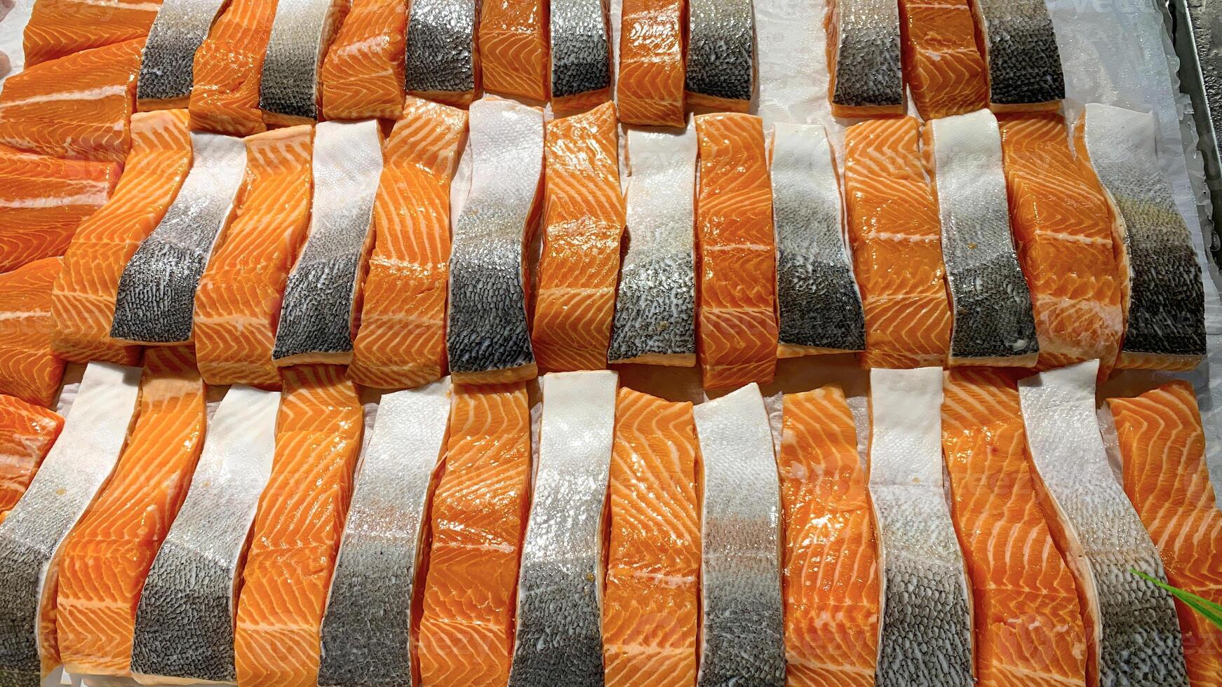 High angle view of slices of salmon fish display at market. Seafood concept photo