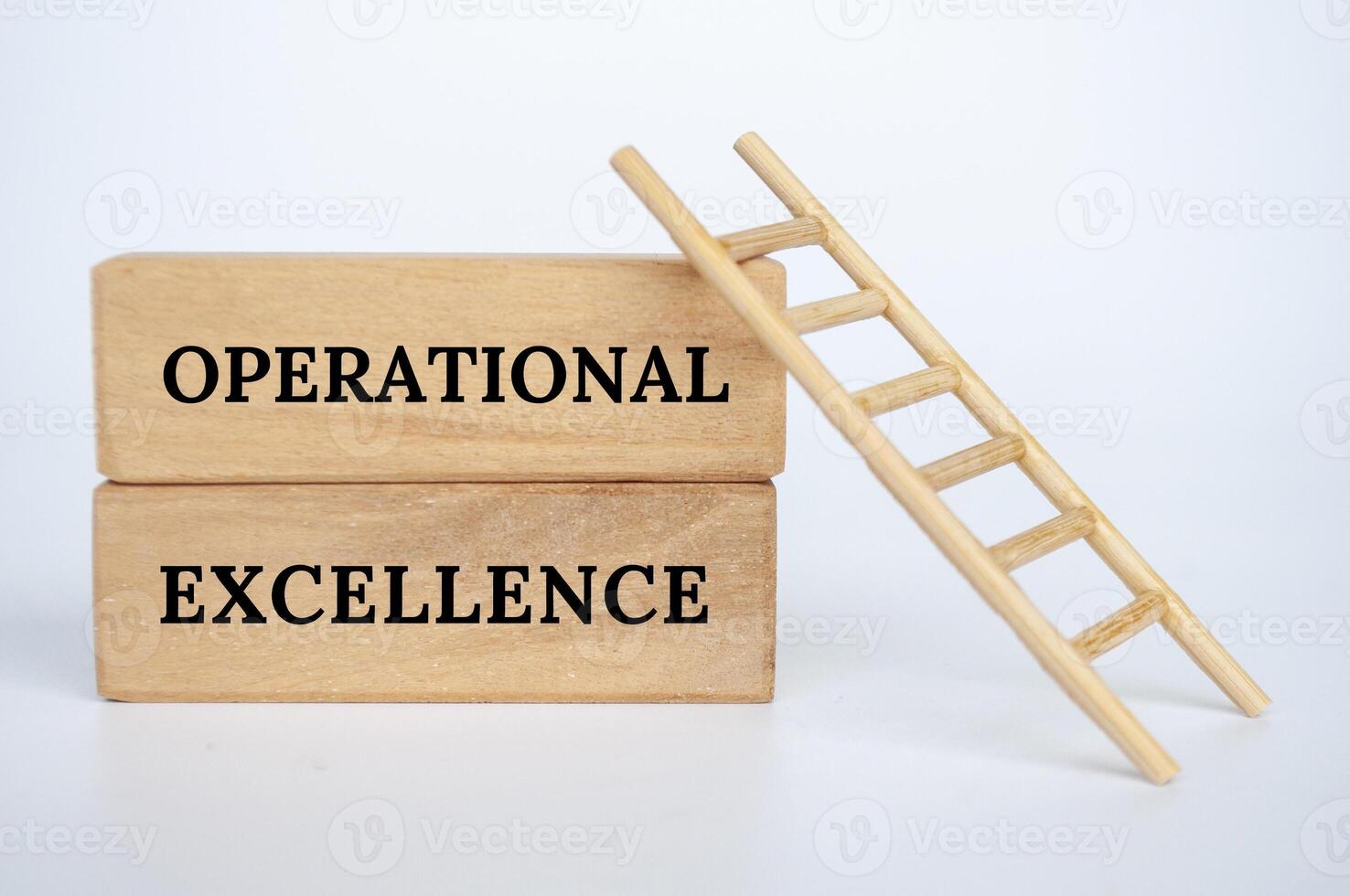 Operational Excellence text on wooden blocks with small ladder background. Business concept photo