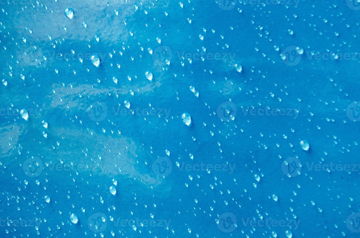Top view of droplets with blue color background suitable for wallpaper photo
