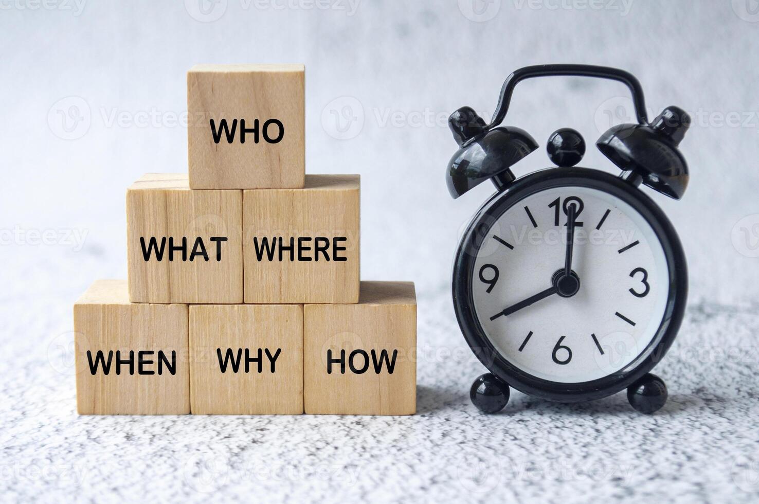 Who, What, Where, When, Why and How text on wooden cubes with table clock background. Fact finding concept photo
