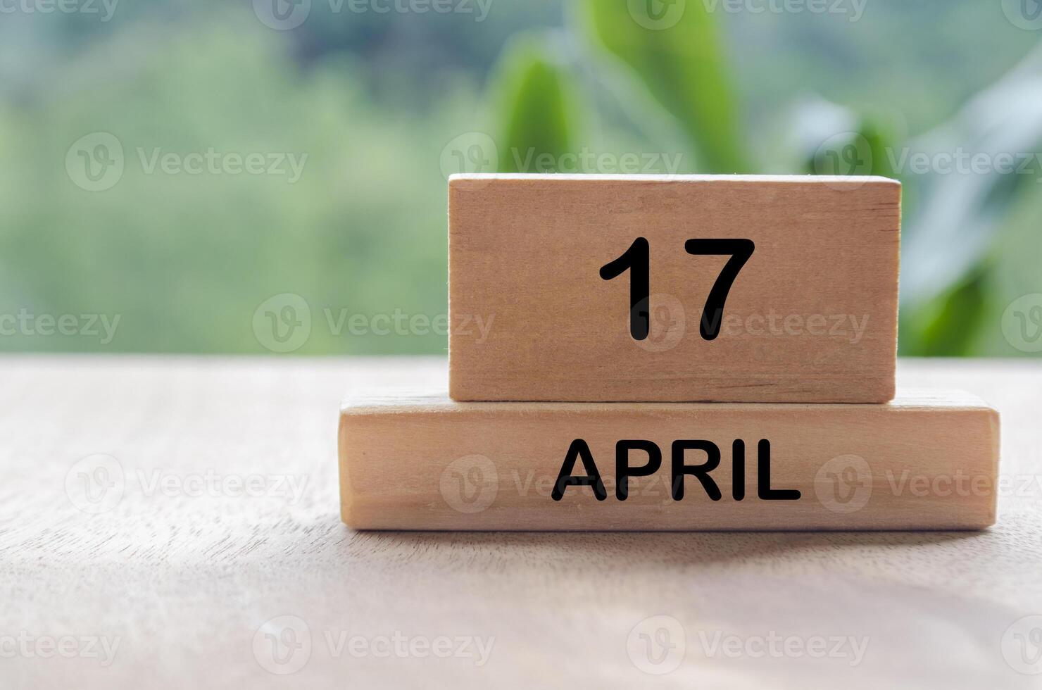 17 April calendar on wooden table with customizable space for text, ideas or messages. Calendar and copy space concept. photo