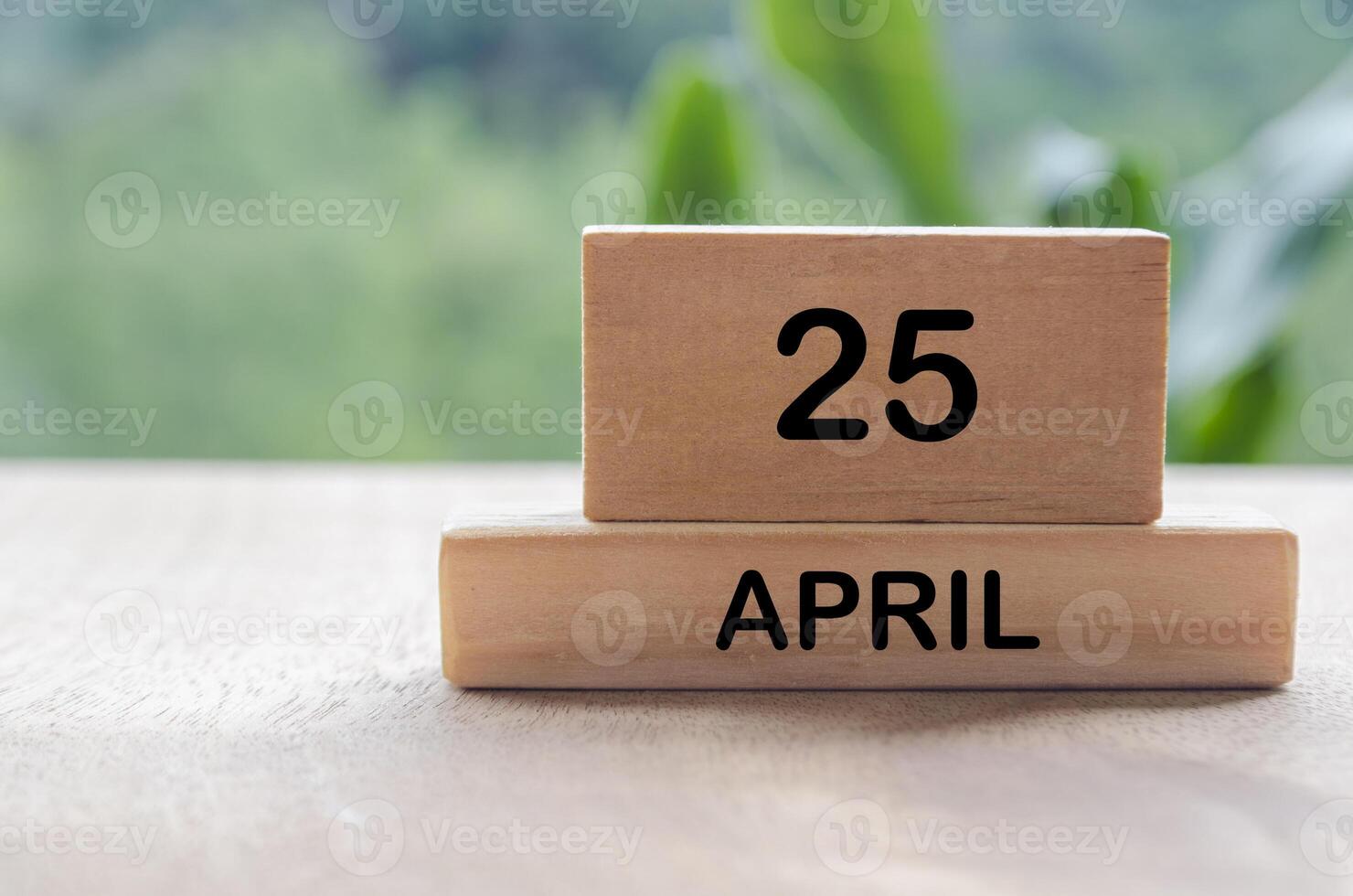 25 April calendar on wooden table with customizable space for text, ideas or messages. Calendar and copy space concept. photo