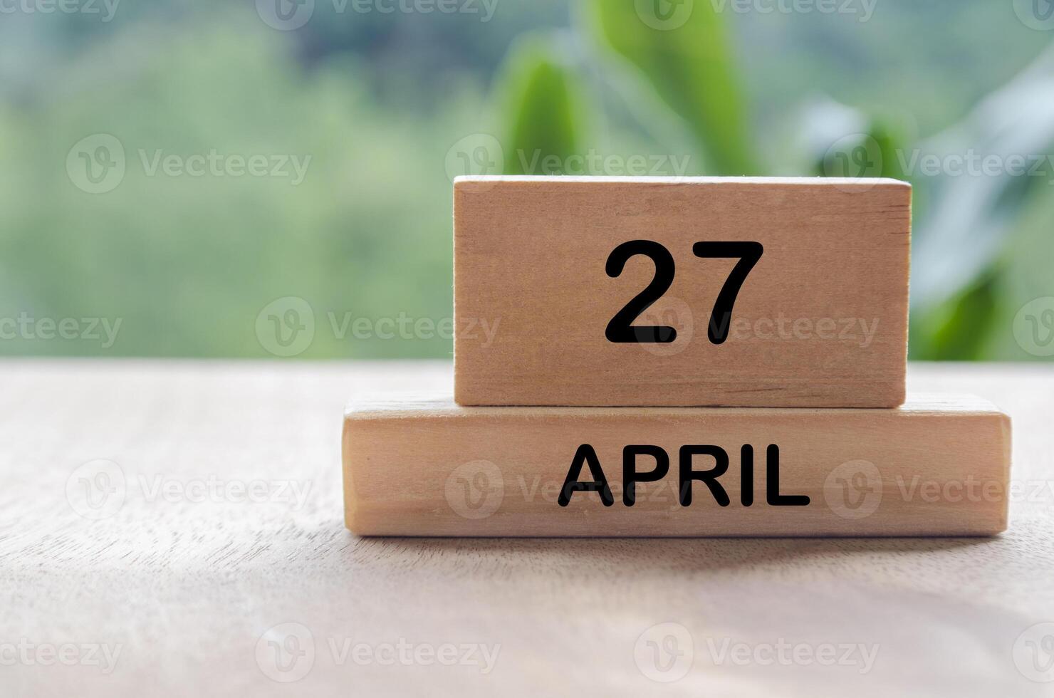 27 April calendar on wooden table with customizable space for text, ideas or messages. Calendar and copy space concept. photo