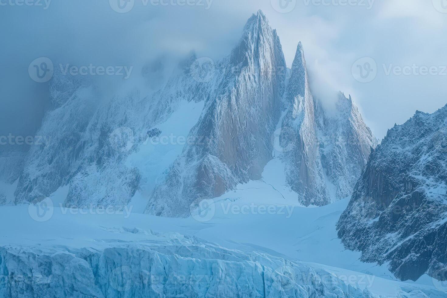 A large mountain with snow on top and ice photo