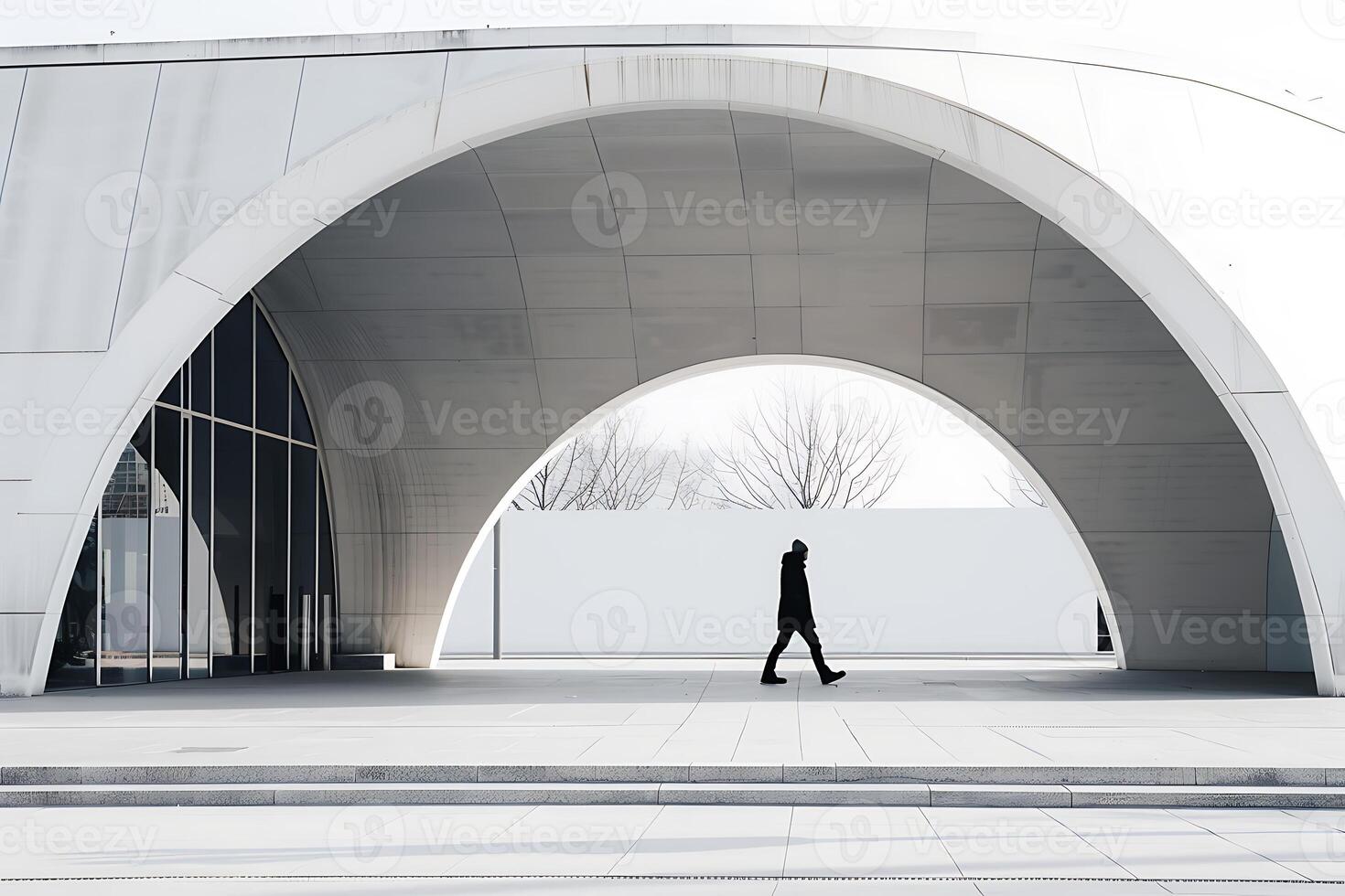 A person walking through an arched building photo