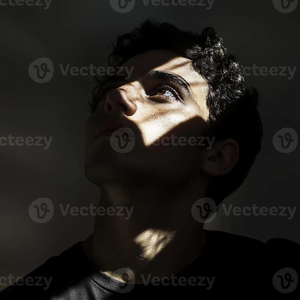 A man is looking up at the sky with his eyes closed photo