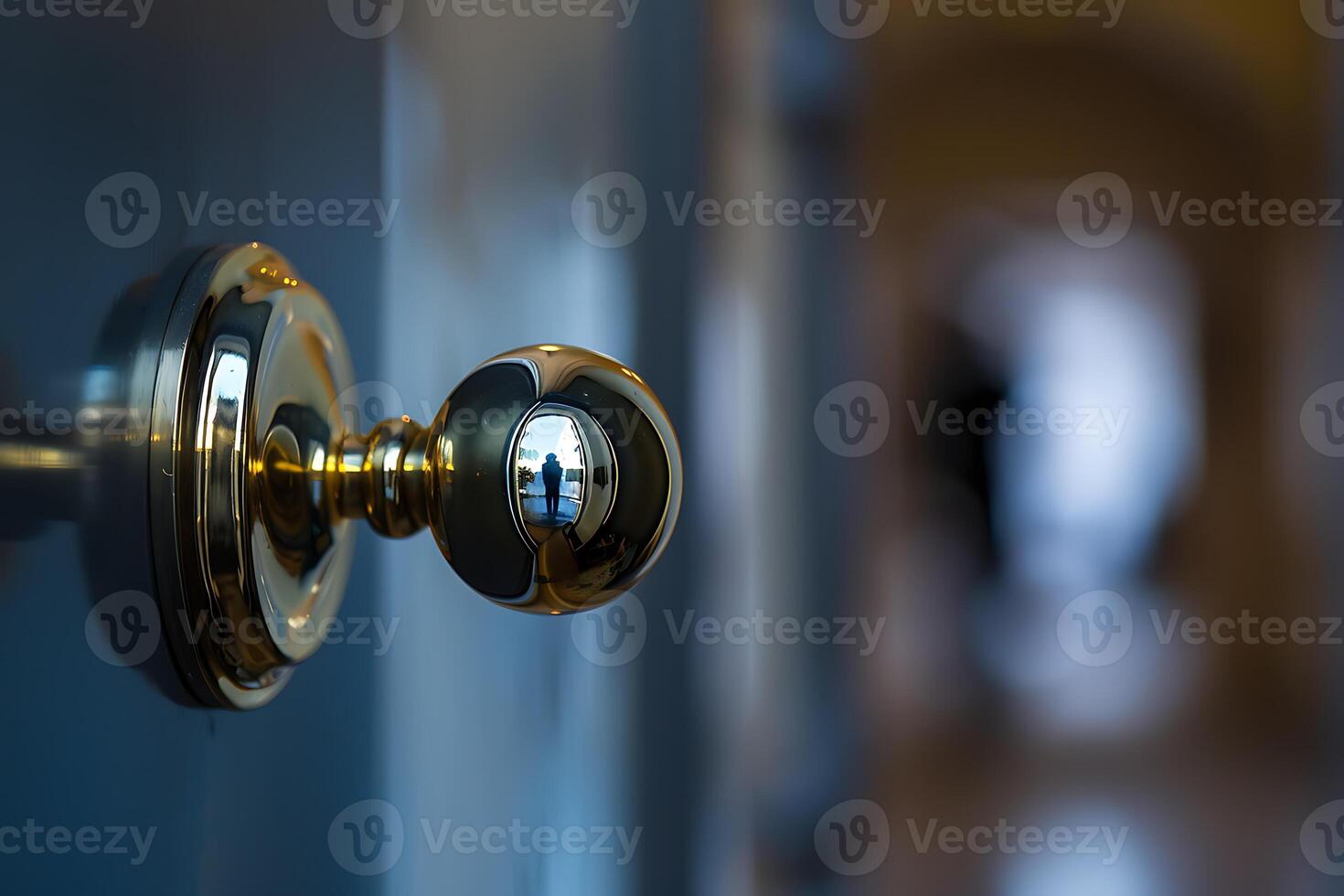A door knob with a reflection of a person in the background photo