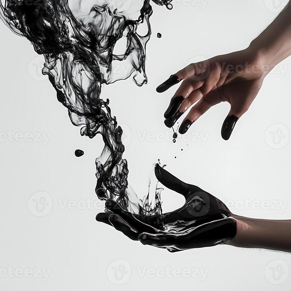 A hand is holding a black liquid photo