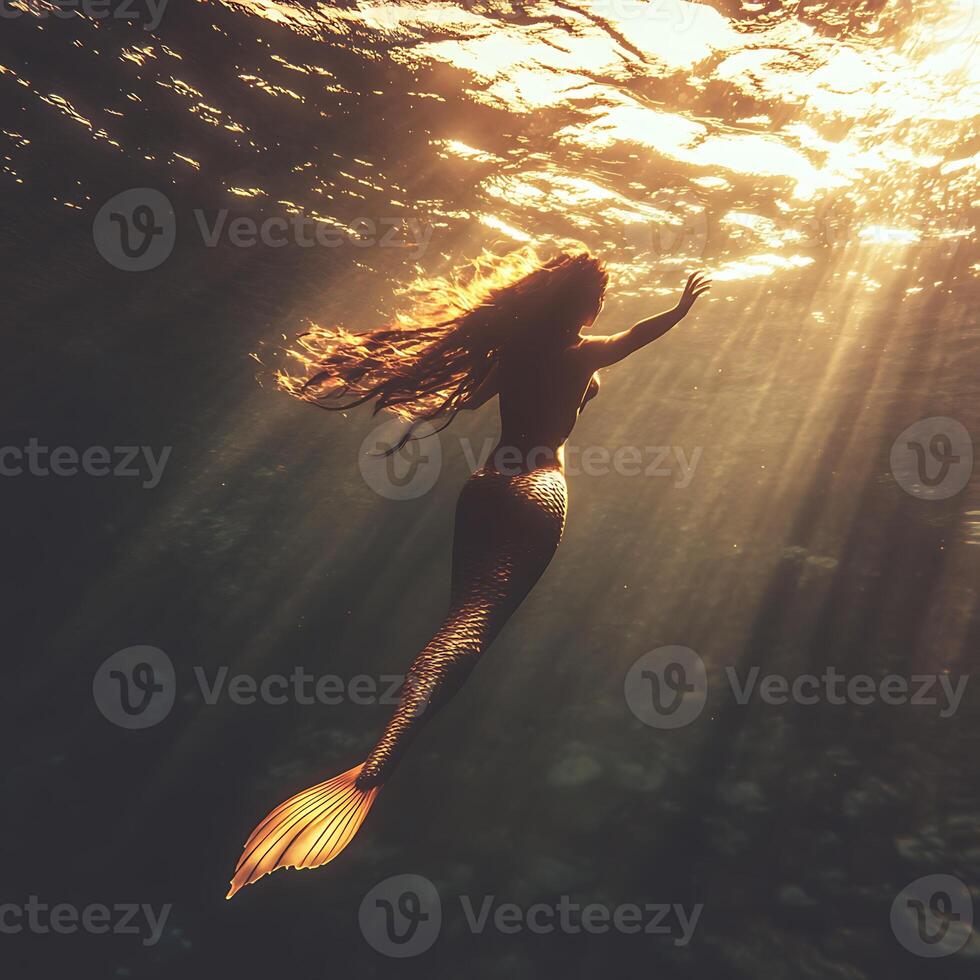 A mermaid is swimming in the ocean photo