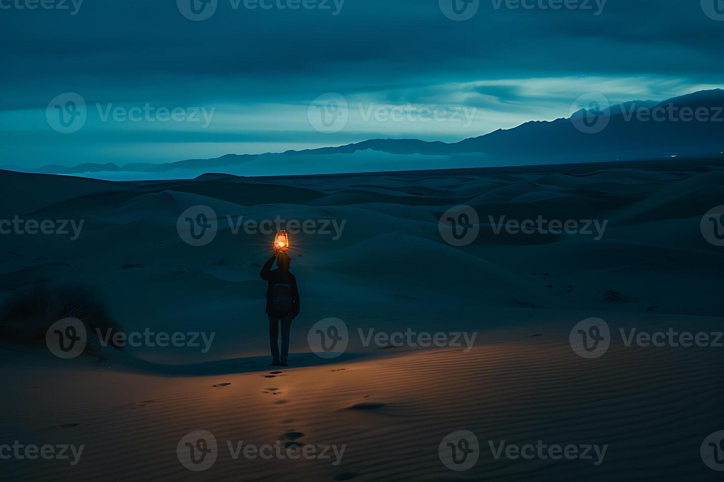 A person standing in the middle of a desert holding a torch photo
