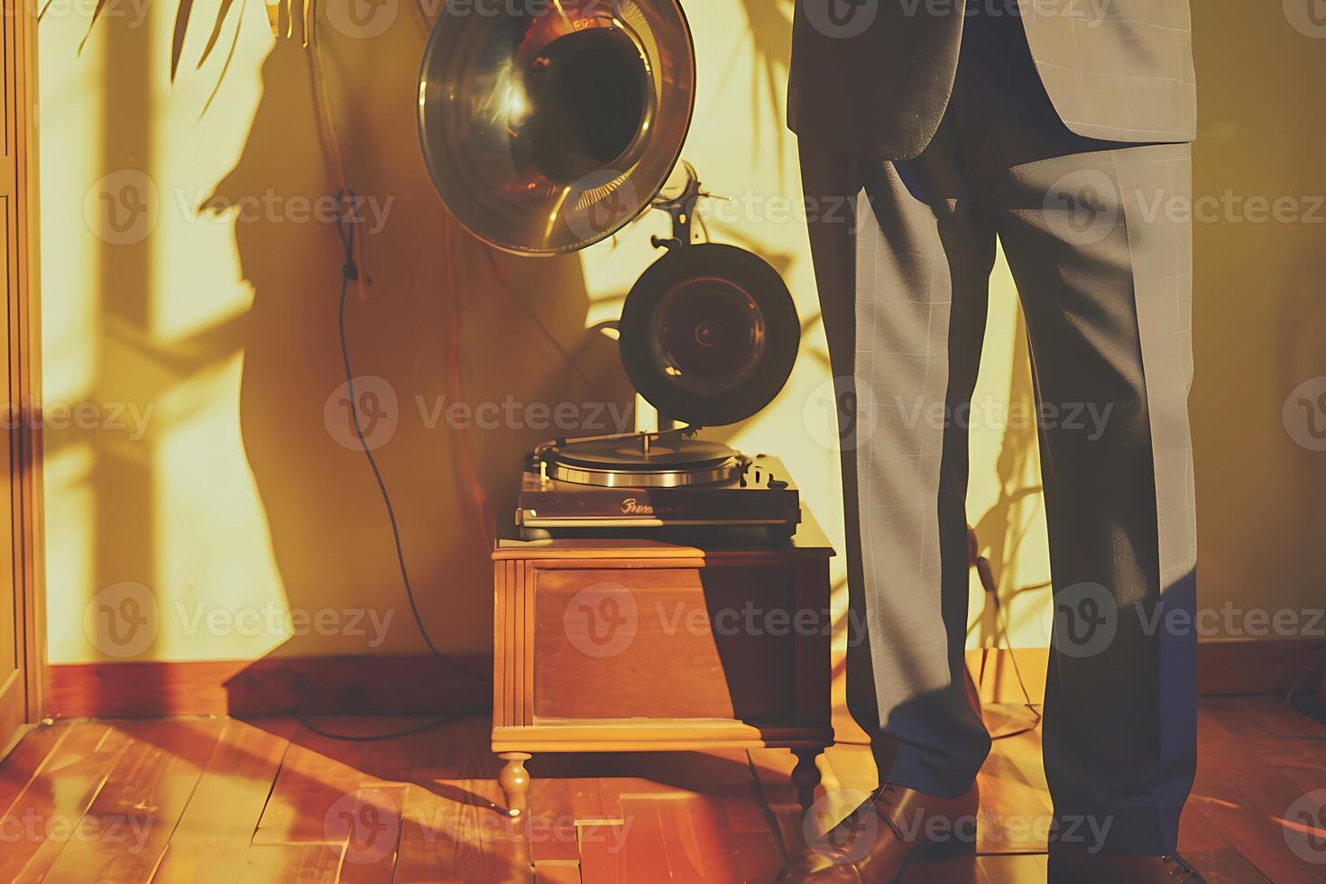 A man in a suit standing next to a vintage record player photo