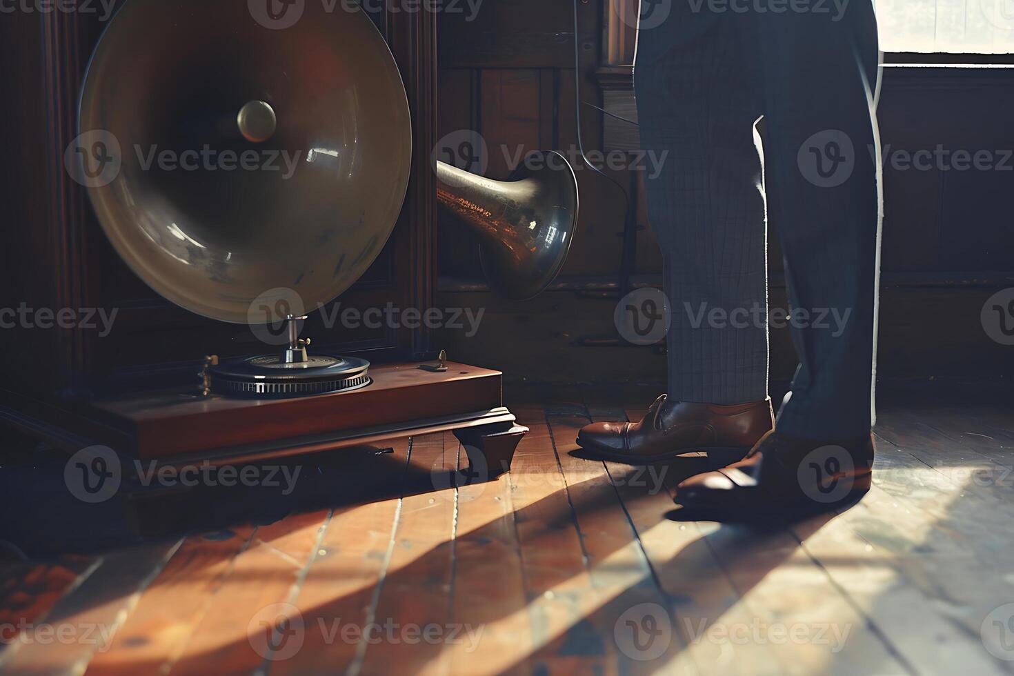 A man in a suit standing next to a large brass gramophone photo