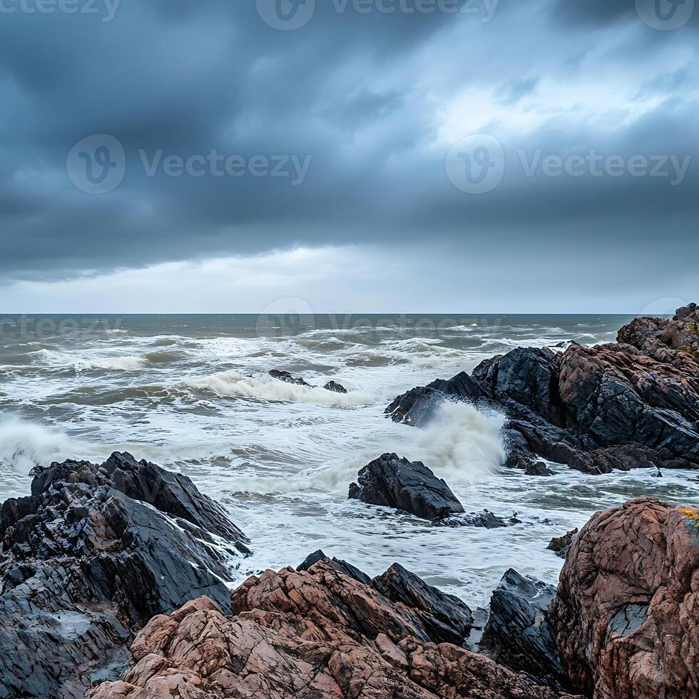A person is standing on a rocky shoreline photo