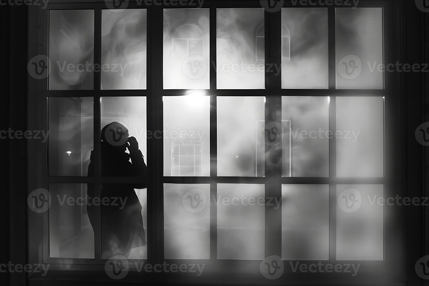 A person standing in front of a window with a foggy background photo