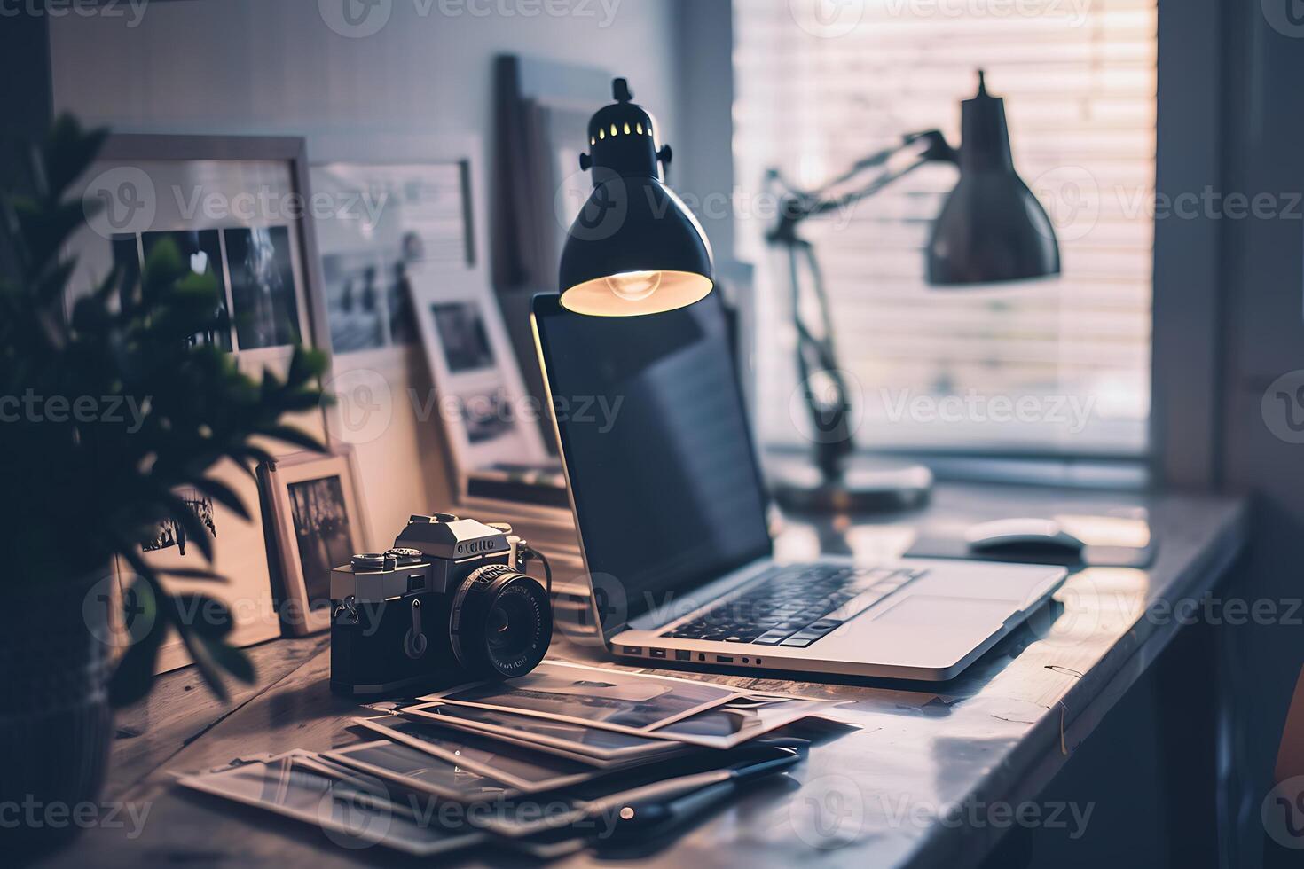 A laptop sitting on a desk with a lamp on it photo