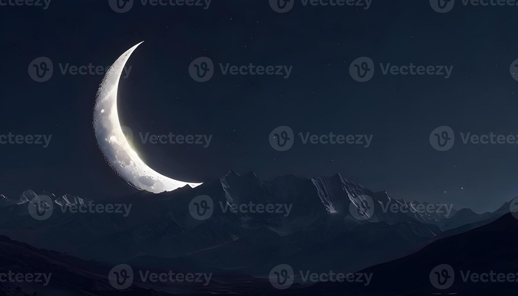 A crescent moon is seen in the night sky photo