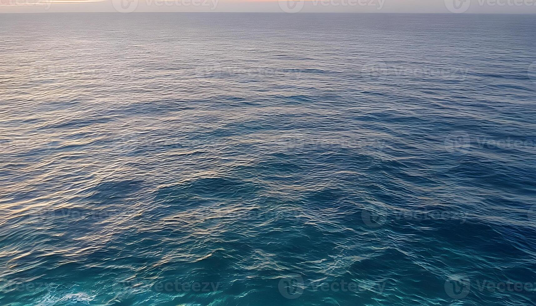 An aerial view of the ocean at sunset photo