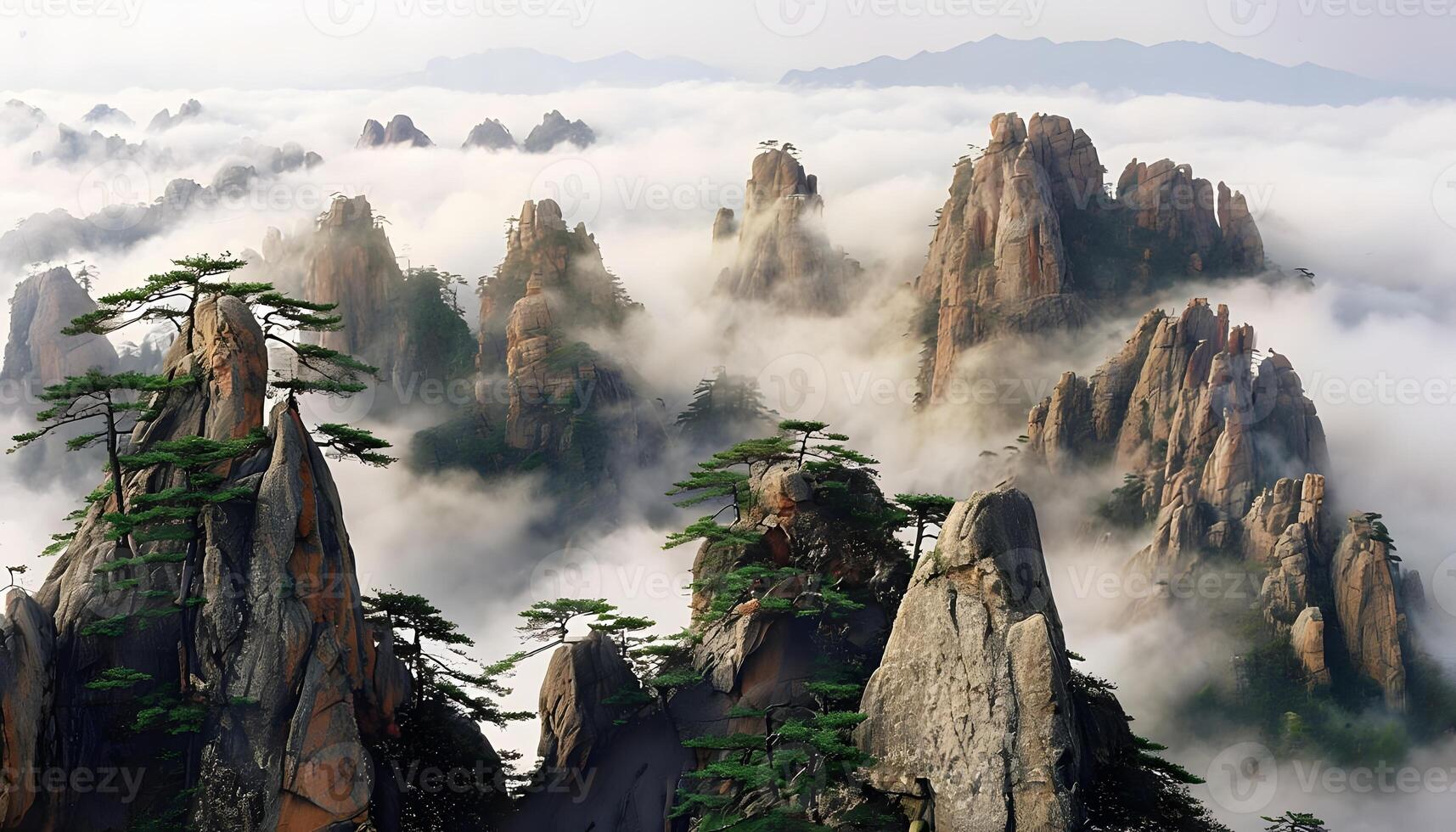The mountains are covered with clouds and trees photo