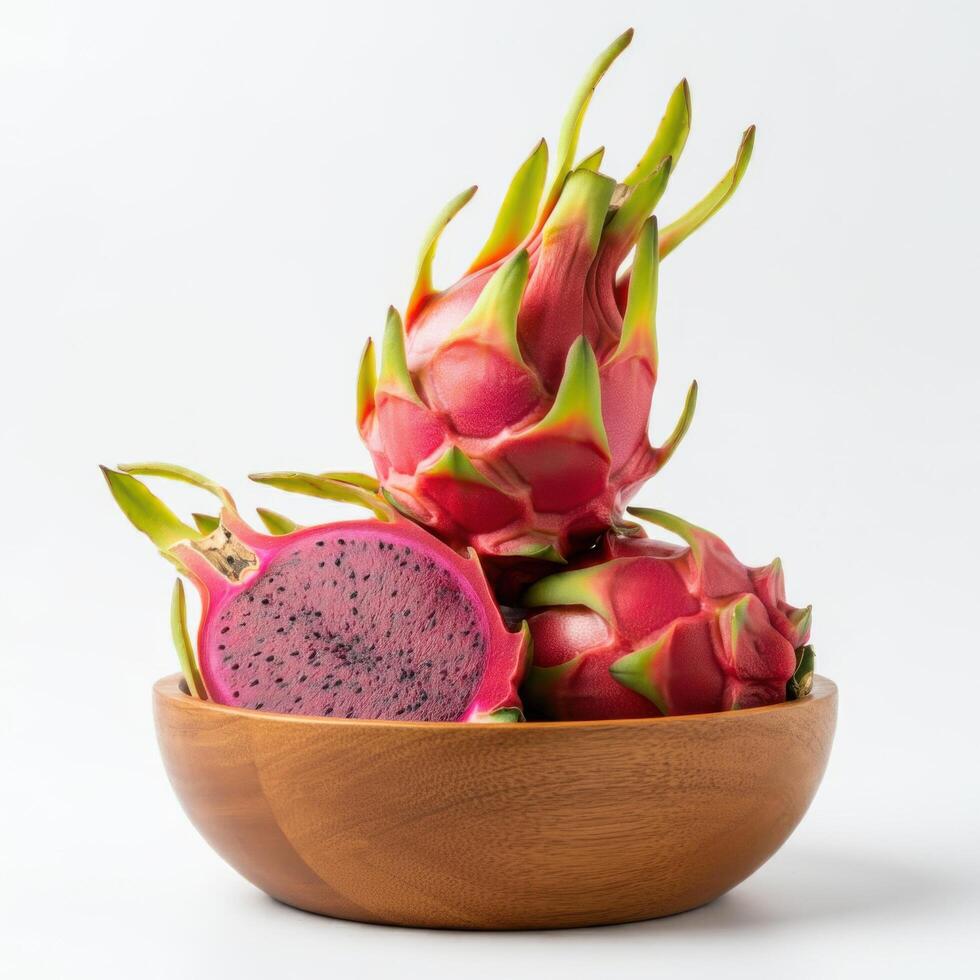 Vibrant dragon fruit chunks arranged neatly inside a wooden bowl over white setting photo