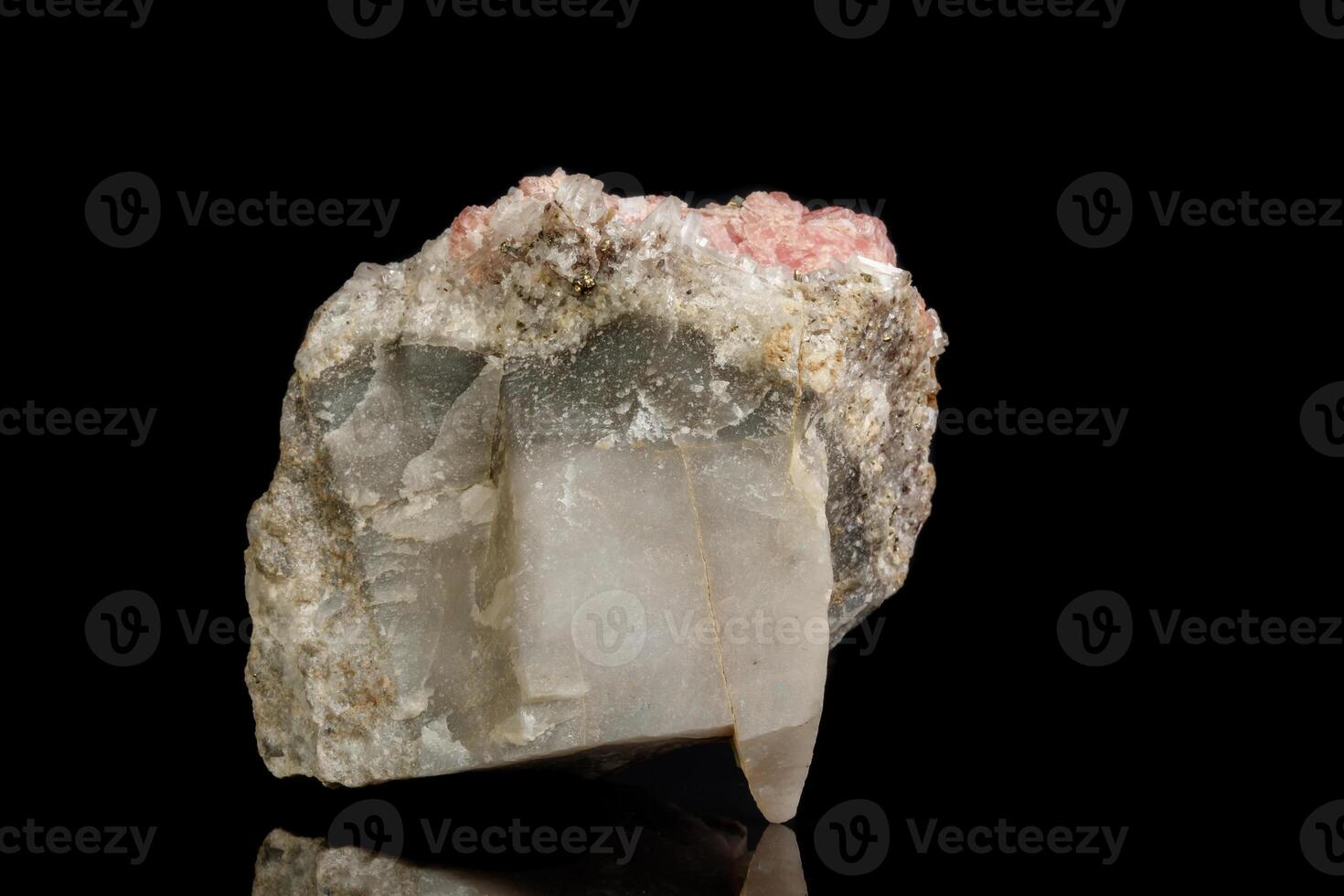 close up of the mineral stone Rhodochrosite with fluorite on a black background photo