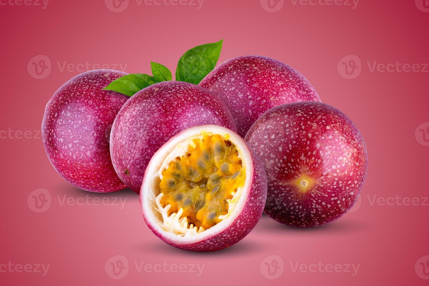 Whole passionfruit and a half of maracuya isolated on a red background photo