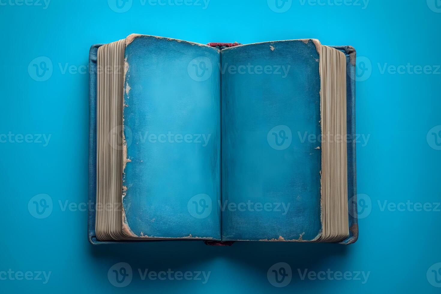 Vintage Open Book on Vibrant Blue Background for Design and Inspiration photo