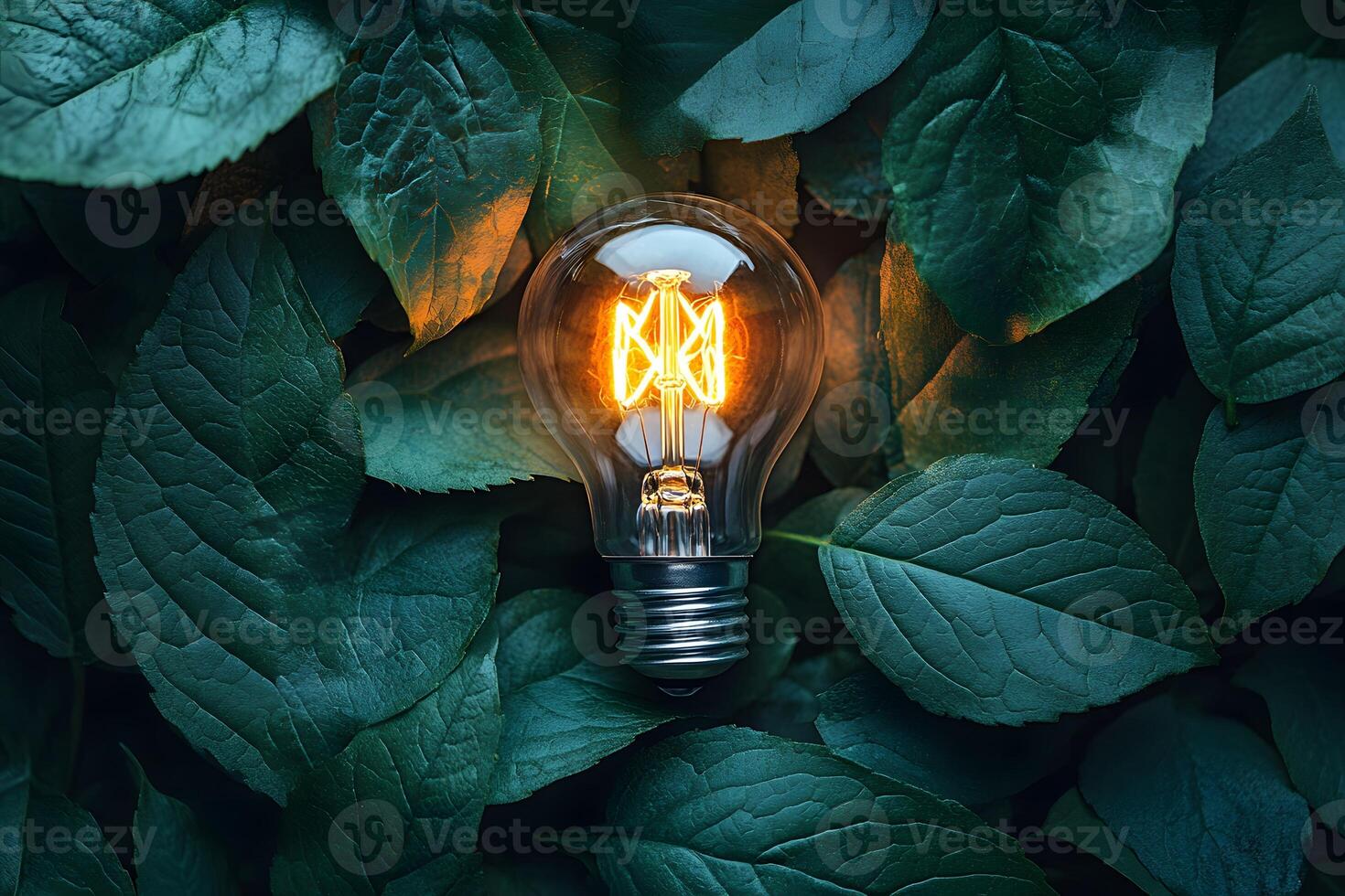 Illuminated Light Bulb Amidst Lush Green Leaves - Concept of Eco-Friendly Energy photo