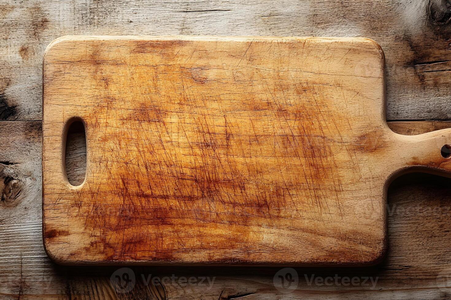 Rustic Wooden Cutting Board on Aged Wood Surface for Culinary Design photo