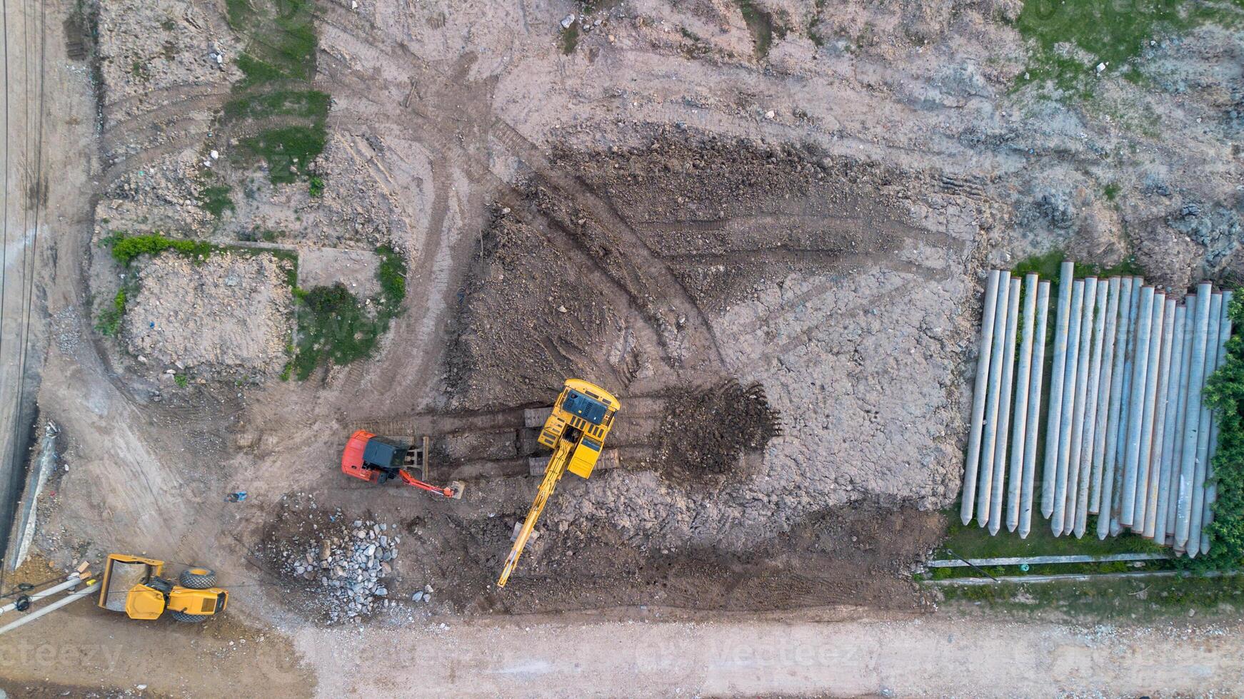 Aerial view of a construction site with excavator and dump truck photo