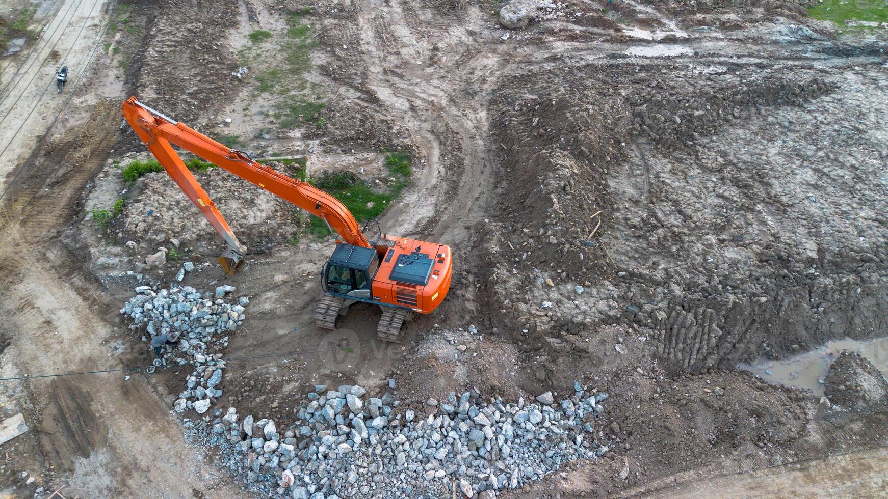 Aerial view of a construction site with an excavator bucket. photo