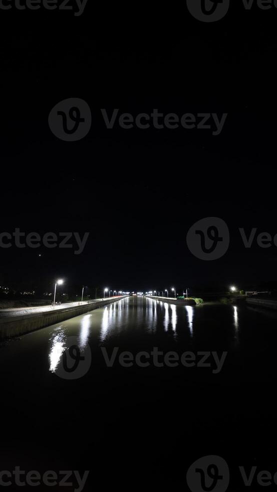 Night view of river at night with lights reflected on water surface. photo