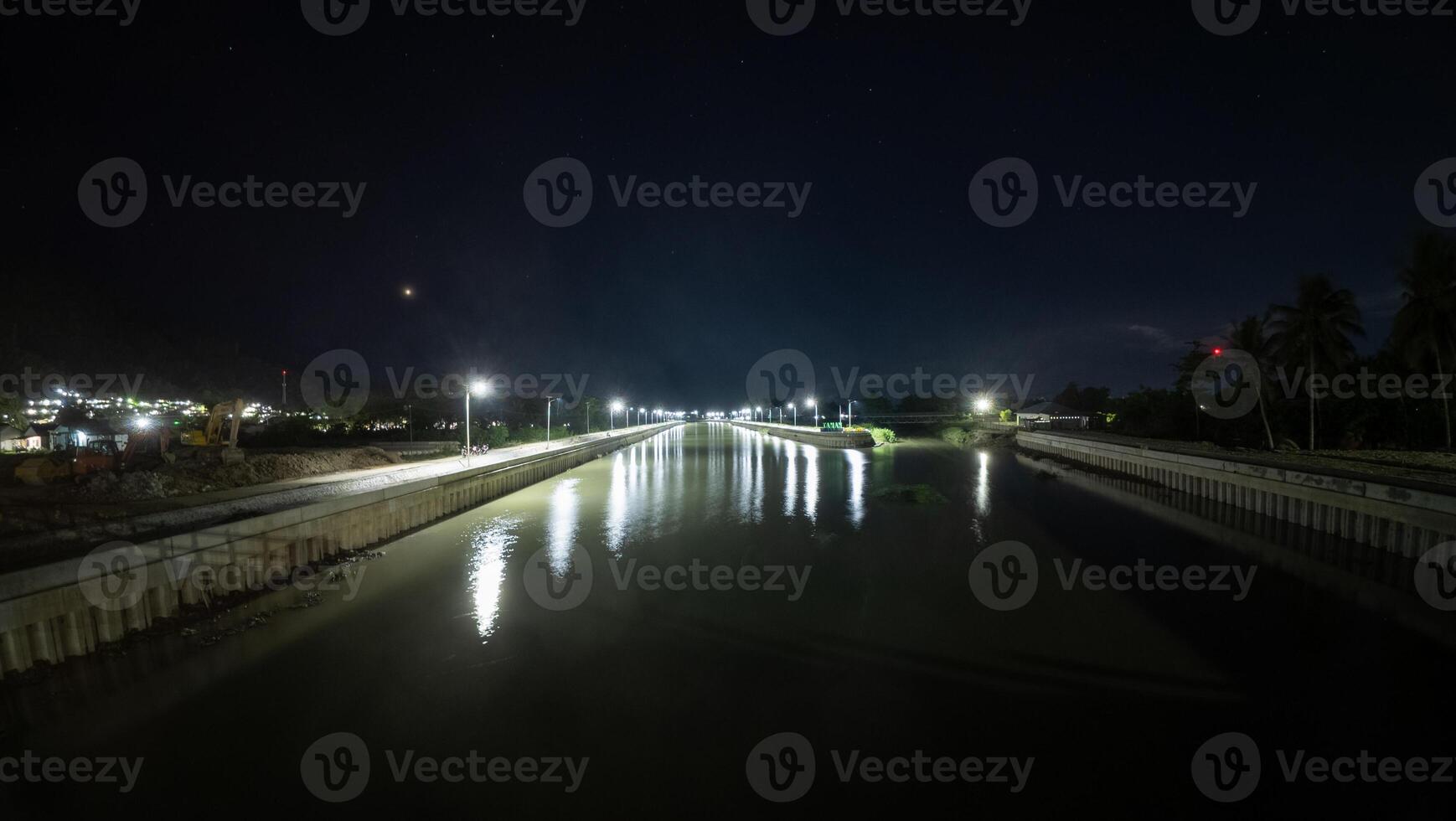 Night view of the bridge over the river with reflection in the water photo
