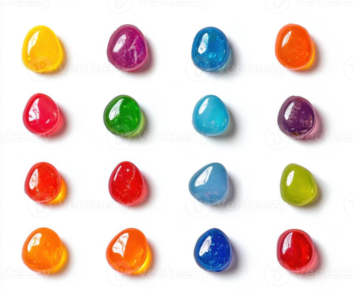 Colorful variety of gel candy arranged in a grid on a white background photo